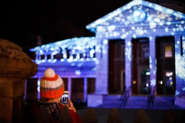 Bow taking a photo of the Bathurst Courthouse illuminated with a winter theme.