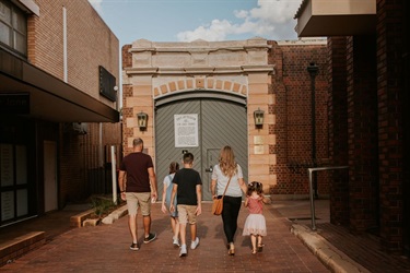 Family walking into the entrance of the Old Dubbo Gaol.