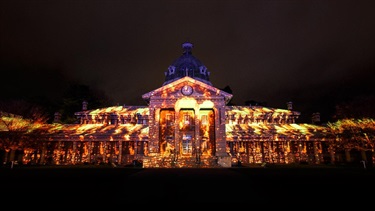 Bathurst Courthouse illuminated with a projection of fire burning.